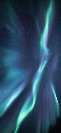 an aurora bore is seen in the night sky with green and blue lights on it