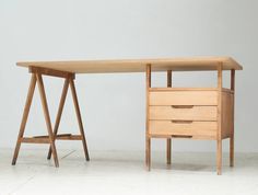 a wooden desk with two drawers underneath it