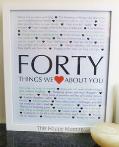 a framed poster with the words forty things we love about you on it next to a candle