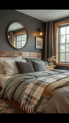 a bedroom with a large bed and two round mirrors on the wall above it's headboard