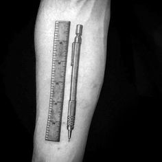 a pencil and ruler tattoo on the arm