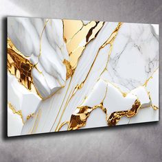 a white and gold marble wall art piece