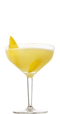 a glass filled with a yellow drink and garnished with an orange slice on the rim