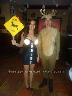 a man and woman dressed up as deer and moose with lights on their heads standing next to each other