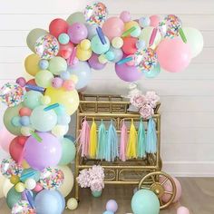 balloons and streamers are on the floor in front of a baby crib