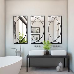 a bathroom with two sinks and a bathtub in front of the mirrors on the wall