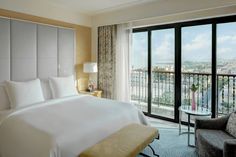 a hotel room with a balcony overlooking the city