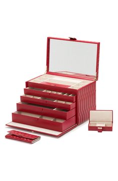 an open red jewelry box with five compartments and two trays on the bottom, next to each other