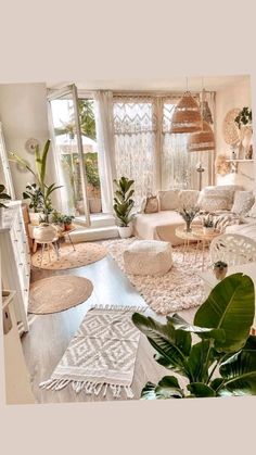 a living room filled with lots of furniture and plants on top of rugs in front of windows