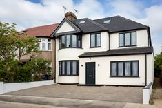 a large white two story house with black windows