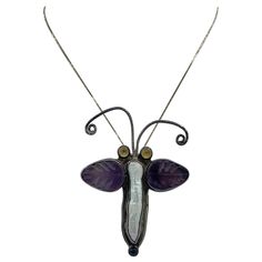 This is a stunning vintage Echo Of The Dreamer Pendant or Brooch in the form of a Butterfly or Moth with carved Amethyst Wings, a stunning Pearl body, Lapis Lazuli at the tail and in Sterling Silver. The wonderful insect can be worn as a pendant or as a brooch. It has dramatic design and is such a delight of color and form. And insect jewels are all the rage today. I love the elongated pearl set in the body with the carved amethyst wings and the blue lapis accent at the base. The pendant is 2 7/ Moth Pendant, Blue Lapis, Pearl Set, A Butterfly, Lapis Lazuli, Moth, The Dreamers, Insects, Amethyst