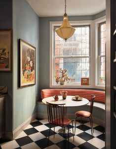 a dining room with checkered flooring and a round table surrounded by two chairs