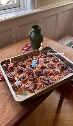 a pan filled with cupcakes on top of a wooden table