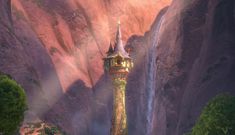 a tall tower sitting in the middle of a lush green forest next to a waterfall