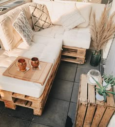 a white couch sitting on top of a wooden pallet