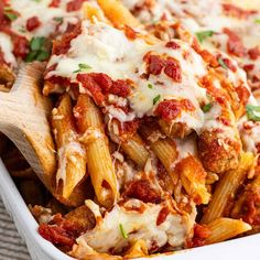 a casserole dish filled with pasta and meat covered in marinara sauce, cheese and parmesan