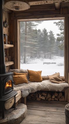 a log cabin with a large window and wood burning stove