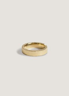 a gold band ring on a white background