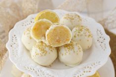 a white plate topped with lemon covered cookies