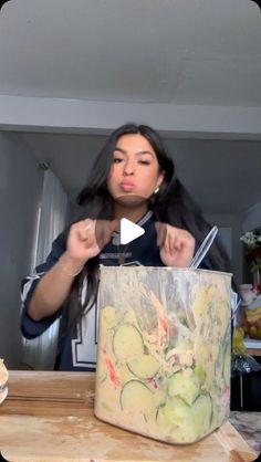 a woman is cutting up vegetables in a bag