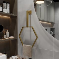 a modern bathroom with gold accents and white tiles on the walls, along with shelving