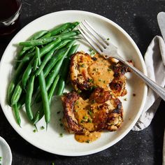 a white plate topped with meat and green beans