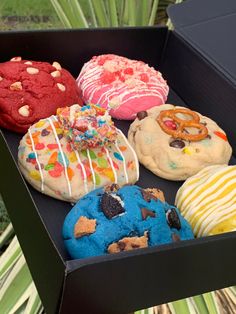 an open box filled with different flavored donuts