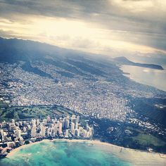 an aerial view of a city and the ocean