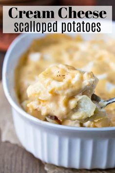 a spoonful of cream cheese scalloped potatoes in a white casserole dish