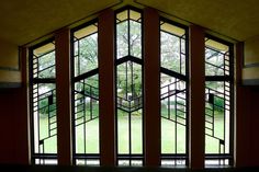 an empty room with stained glass windows and stairs