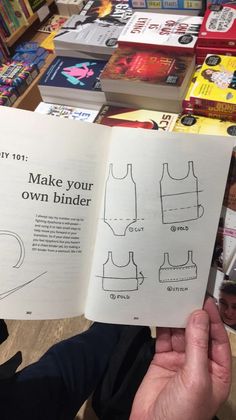 an open book with instructions on how to make your own binder in front of a pile of books