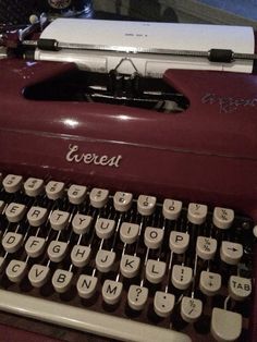 an old fashioned typewriter sitting on top of a table