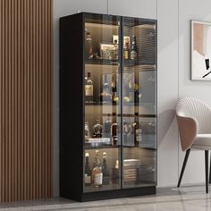 a glass door cabinet with liquor bottles in the front and behind it is a chair