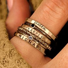 Personalized stackable ring set, engraved with names, dates, or special words. All 6 rings shown in the photos are included in this listing.  Choose between mixed metals, fine silver, or 14K yellow gold-filled for your set! MIXED METALS include: 2 - yellow gold-filled name rings 1 - fine silver name ring 2- sterling silver birthstone rings 1 - yellow gold-filled beaded ring This ring set includes three name rings, a beaded ring, and two cz rings Metal: 14k gold filled, .999 fine silver, .925 ste Stackable Birthstone Rings Rose Gold, Cool Mothers Rings., Affordable Everyday Stackable Rings With Simple Design, Luxury Engraved Stackable Promise Ring, Affordable Classic Stackable Rings, Cheap Everyday Meaningful Rings, Cheap Bohemian Stackable Rings, Stackable Mothers Rings Names, Birthstone Ring Mothers Stacked