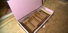 an open drawer sitting on top of a hard wood floor