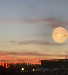 a hot air balloon is flying in the sky at sunset or dawn over a city