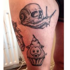 a skull and a cupcake tattoo on the leg