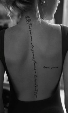 the back of a woman's neck with an inscription on it that reads,