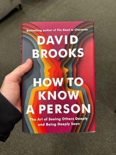 a person holding up a book about how to know a person