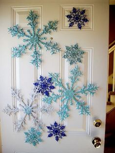 snowflakes are hanging on the front door to decorate with blue and white frosting