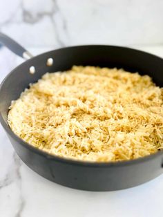 a pan filled with rice on top of a white counter