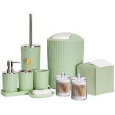 green bathroom accessories including soap dispenser, toothbrush holder and tissue dispenser