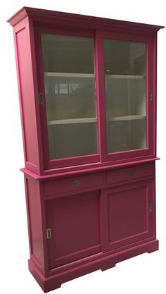 a pink china cabinet with glass doors on the top and bottom shelves, against a white background