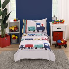 a child's bedroom with blue walls and toys on the floor, including a toy train bedding set