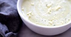 a white bowl filled with soup on top of a table