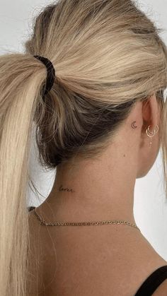 the back of a woman's head with her hair in a pony tail styled into a ponytail