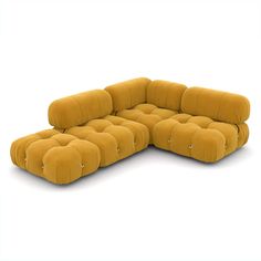 a large sectional couch with buttons on the back and arms, in mustard yellow velvet