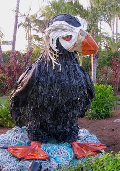 a large bird statue sitting on top of a blue blanket