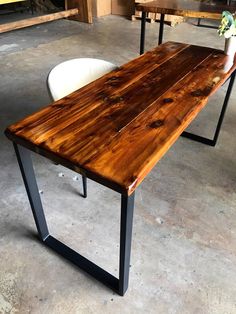 a wooden table sitting on top of a cement floor