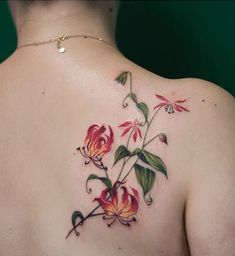 the back of a woman's shoulder with flowers on it